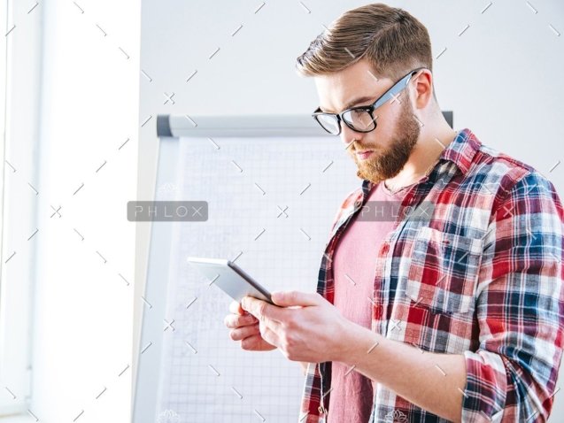 demo-attachment-176-handsome-serious-man-with-beard-standing-and-PBYSCKB